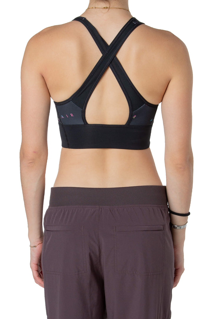 Top deportivo Nike Air negro con logo neón, vista trasera