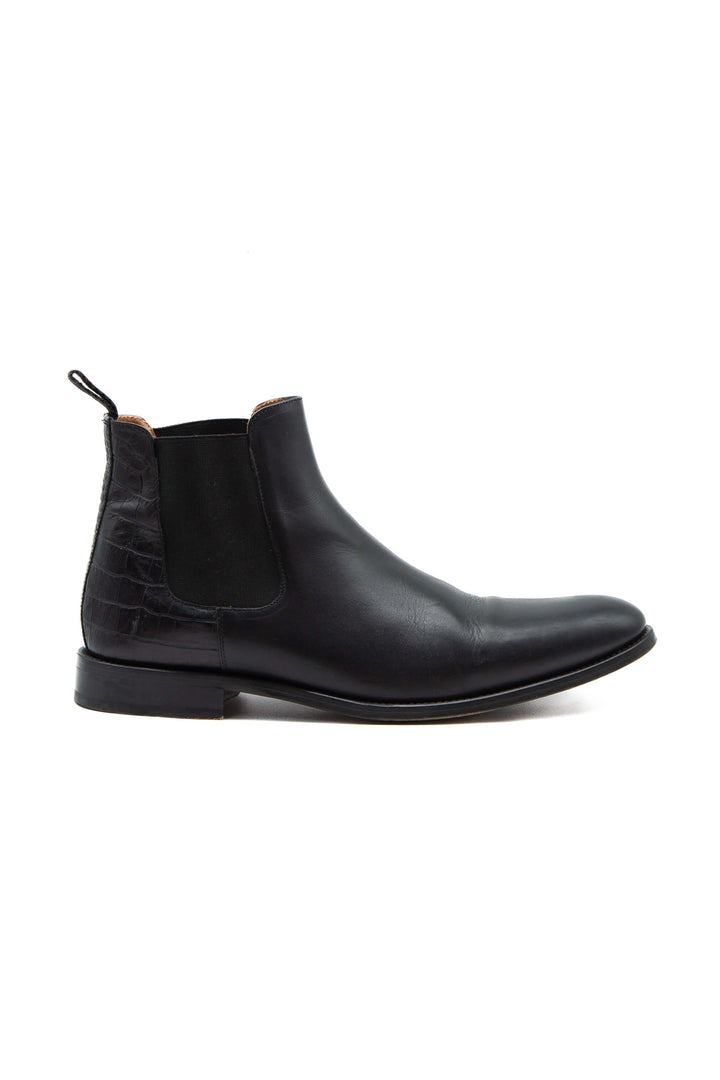 Vista lateral de bota Chelsea Taft en piel negra