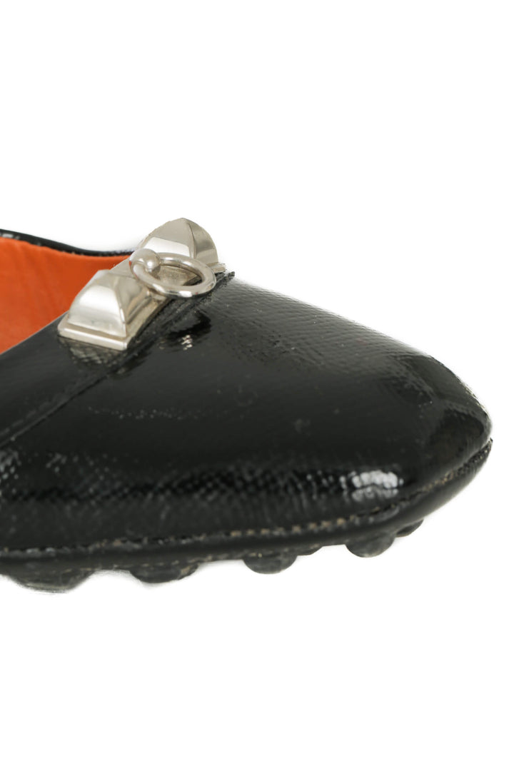 Mocasines Hermès de charol negro con herraje plateado, detalle del herraje en la punta